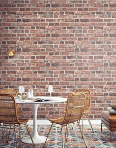 a brick wall with chairs and a table in front of it on a tiled floor