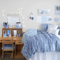 a bedroom with blue and white decor on the walls, bedding and desks