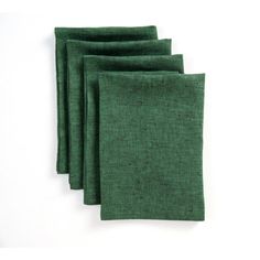 four green linen napkins sitting on top of a white table next to each other