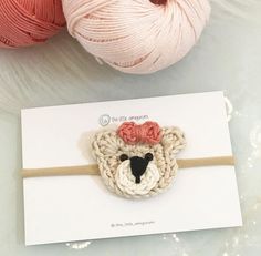 there is a crochet bear headband on top of a card