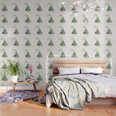 a bedroom with a bed, chandelier and wallpaper that has christmas trees on it