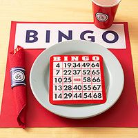 a red and white place mat with a game on it next to a cup of coffee