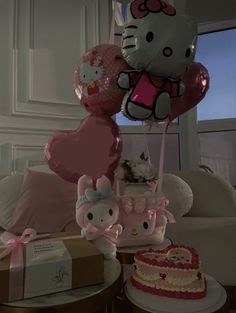 hello kitty balloons and other items on a table