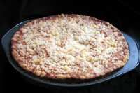 a pizza sitting on top of a pan covered in toppings