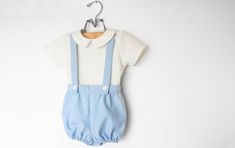 My current processing time is 3-4 weeks before shipping. Please do not order if you need your item(s) before then :)  If you're looking for the perfect vintage style oufit for your little guy, look no further! These baby blue suspender bloomers are perfect for weddings, baptisms, holidays, christenings, family photos, or dressed down for everyday wear. They pair perfectly with our linen collared shirts. The suspender shorts feature a flat front waistband, and elastic in the back waistband. The suspender straps button on to the bloomer shorts in the front and back, and have two buttonholes in the back to be able to adjust for longer wear. A velvet ribbon strip where the suspenders cross keeps the straps from slipping off of the shoulders. The suspenders are completely removeable, allowing t Toddler Wedding Outfit Boy, Boys Wedding Outfit, Baby Boy Wedding Outfit, Baby Boy Suspenders, Baby Boy Linen, Baby Boy Easter Outfit Infants, Wedding Outfit For Boys, Baby Boy Baptism Outfit, Baby Boy Easter