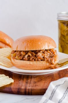 a sloppy joe sandwich on a plate with chips