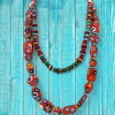 Immerse yourself in the vibrant hues and intricate artistry of this stunning 19" ethnic beaded necklace! 💎 Meticulously handcrafted with a double layer of ceramic beads and authentic African Krobo beads from Ghana, this piece exudes bohemian chic.The vibrant color palette, ranging from fiery reds to deep indigos, creates a mesmerizing rainbow effect that will elevate any outfit. 🌈 Each bead is individually painted by skilled artisans, making every necklace a unique work of art. Whether dressing up for a special occasion or adding a pop of color to your everyday look, this necklace is sure to turn heads. 💫 Embrace global artistry and sustainable fashion with this one-of-a-kind piece that celebrates the rich cultural heritage of Africa. Elevate your jewelry collection with this vibrant et Luxury Multicolor Beaded Fusion Necklaces, Traditional Double Strand Beads For Gift, Handmade Artisan Double Strand Beaded Necklace, Traditional Multicolor Hand Painted Necklace, Multicolor Hand Painted Beaded Bohemian Necklace, Traditional Multicolor Hand-painted Necklace, Traditional Hand Painted Multicolor Necklaces, Multicolor Hand Painted Bohemian Beaded Necklace, Bohemian Multicolor Hand Painted Beaded Necklaces