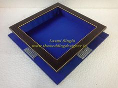 two blue boxes with gold trims on the sides and bottom, one is empty