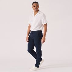 "Introducing our fabulous Regular Fit Stretch Chino Trouser in a classic Navy Blue hue. Designed with both style and comfort in mind, these trousers are made from a high-quality stretch fabric that allows for easy movement and a perfect fit. The regular fit silhouette offers a timeless and versatile look, suitable for any occasion. Whether you're dressing up for a special event or going for a casual outing, these chinos will surely elevate your style game. Complete with a button and zip closure, belt loops, and functional pockets, these navy blue trousers are a must-have addition to your wardrobe. Pair them with a crisp white shirt and loafers for a sophisticated ensemble or dress them down with a cozy sweater and sneakers for a laid-back vibe. Embrace effortless style and impeccable comfo Casual Cotton Chinos For Semi-formal Occasions, Casual Semi-formal Straight Leg Pants, Classic Chinos For Business Casual In Summer, Classic Summer Chinos For Business Casual, Semi-formal Straight Leg Chinos With Pockets, Slim Fit Linen Casual Bottoms, Straight Leg Chinos With Pockets For Semi-formal Occasions, Casual Blue Pants For Semi-formal Occasions, Casual Tapered Leg Bottoms For Semi-formal Occasions