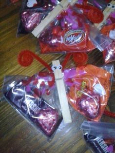 several bags of candy are sitting on the floor next to some lollipops