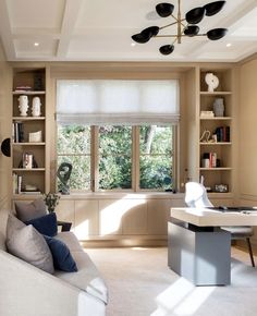 a living room filled with furniture and lots of windows