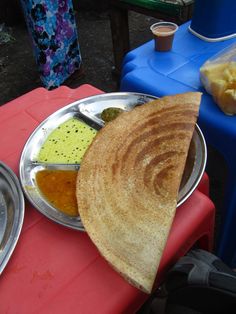 there is a plate with some food on it next to other plates and containers full of food