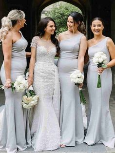 four bridesmaids in grey dresses standing together