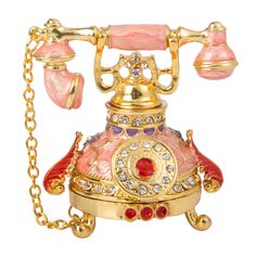 an old fashioned pink and gold phone on a chain