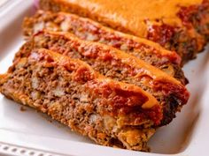 two slices of meatloaf on a white plate