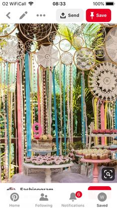 a table topped with cakes and cupcakes under lots of colorful paper streamers