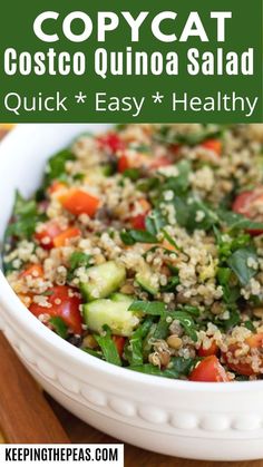 a white bowl filled with couscous quinoa salad on top of a wooden table