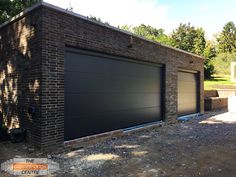 a brick building with two garage doors on the side