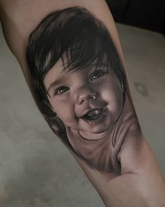 a black and white photo of a child's face on the leg