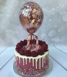 a cake that is sitting on top of a table with a disco ball in the middle