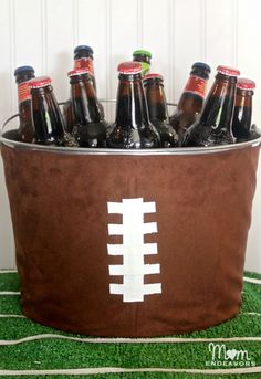 a football cooler with beer bottles in it