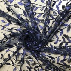 a blue and black scarf with leaves on it