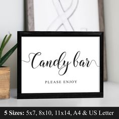 a sign that says candy bar please enjoy on it next to a potted plant