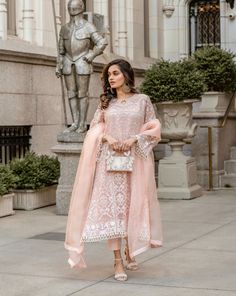 3 piece suit comes with matching pants, and dupatta. The shirt is made from organza and is embroidered and is adorned with three different types of beaded lace on the arms, the front and back border of the shirt, and the neckline. The dupatta is made of organza and the pants are made of mixed raw silk. Each item is handmade and requires exquisite craftsmanship, thus please allow 35-40 days for stitching and 7-8 days for shipping. Orders cannot be changed after 30 minutes of completion of the ord Elegant Organza Palazzo Set For Reception, Elegant Palazzo Set With Sheer Dupatta For Reception, Elegant Palazzo Set For Reception With Sheer Dupatta, Elegant Tissue Silk Palazzo Set With Dabka Work, Organza Lawn Suit With Intricate Embroidery For Reception, Organza Lawn Suit With Dabka For Reception, Elegant Pink Unstitched Suit With Sheer Dupatta, Elegant Pink Georgette Lawn Suit, Elegant Sets With Sheer Dupatta For Reception