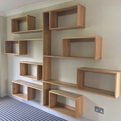 a room with several wooden shelves on the wall