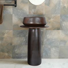 a bathroom sink sitting under a mirror next to a faucet and towel rack