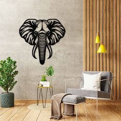 an elephant head is mounted on the wall above a chair and table in a modern living room