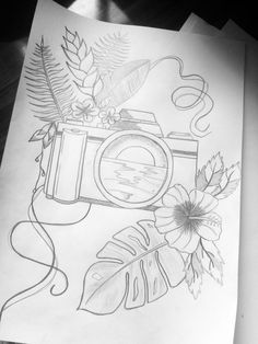 a drawing of a camera with flowers and leaves around it on top of a piece of paper