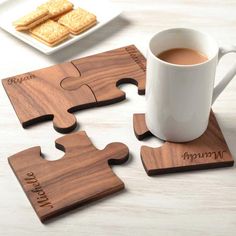 a cup of coffee sitting on top of a wooden puzzle