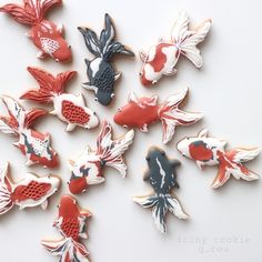 several decorated cookies are arranged in the shape of goldfishs and koi fish