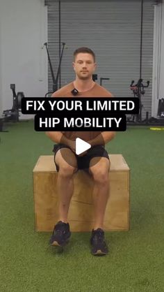 a man sitting on top of a wooden bench in front of a gym equipment area