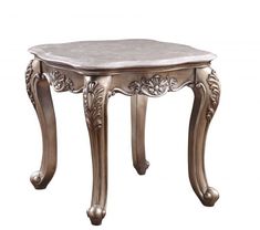 an ornate silver table with marble top