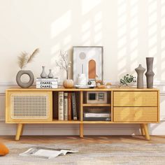 a sideboard with books and vases on it