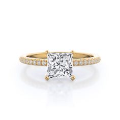 a princess cut diamond engagement ring with pave set diamonds on the shoulders and sides