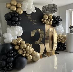 a birthday decoration with balloons and decorations on the wall in front of a large number sign