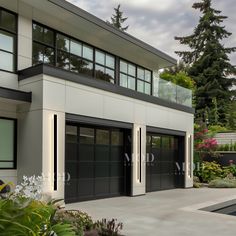 an image of a modern house with two garages