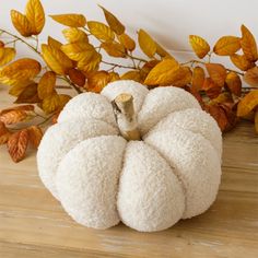 a white pumpkin sitting on top of a wooden table