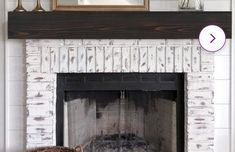 a white brick fireplace with a mirror above it