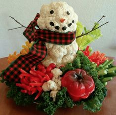 a snowman made out of vegetables on top of a table