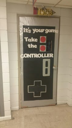 a door with an advertisement on it that says, it's your game take the controller