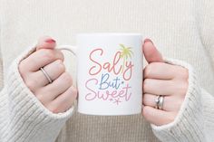 a woman holding a coffee mug with the words salty but sweet on it