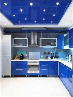 a kitchen with blue cabinets and stainless steel appliances