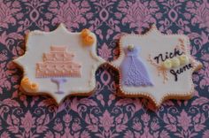 two decorated cookies sitting on top of a table