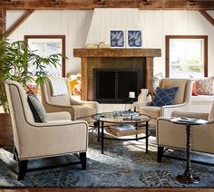 a living room filled with furniture and a fire place in the middle of a room