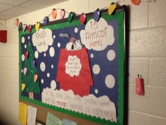 a bulletin board on the wall in a school classroom with decorations and notes pinned to it