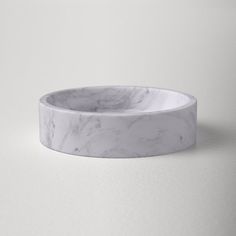 a white marble bowl sitting on top of a table